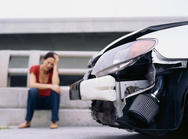 A woman worried about her car and her finances after a car accident in Alpharetta, Georgia