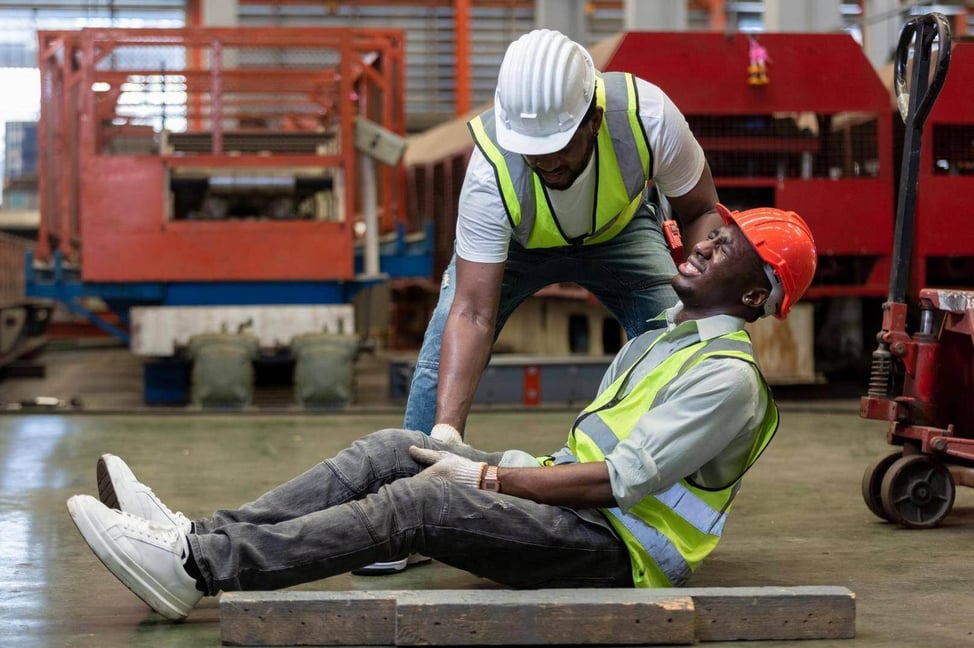 A construction worker being helped by another worker who has been injured in Alpharetta, Georgia