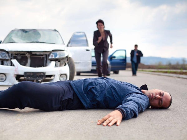 woman running to assist an injured man